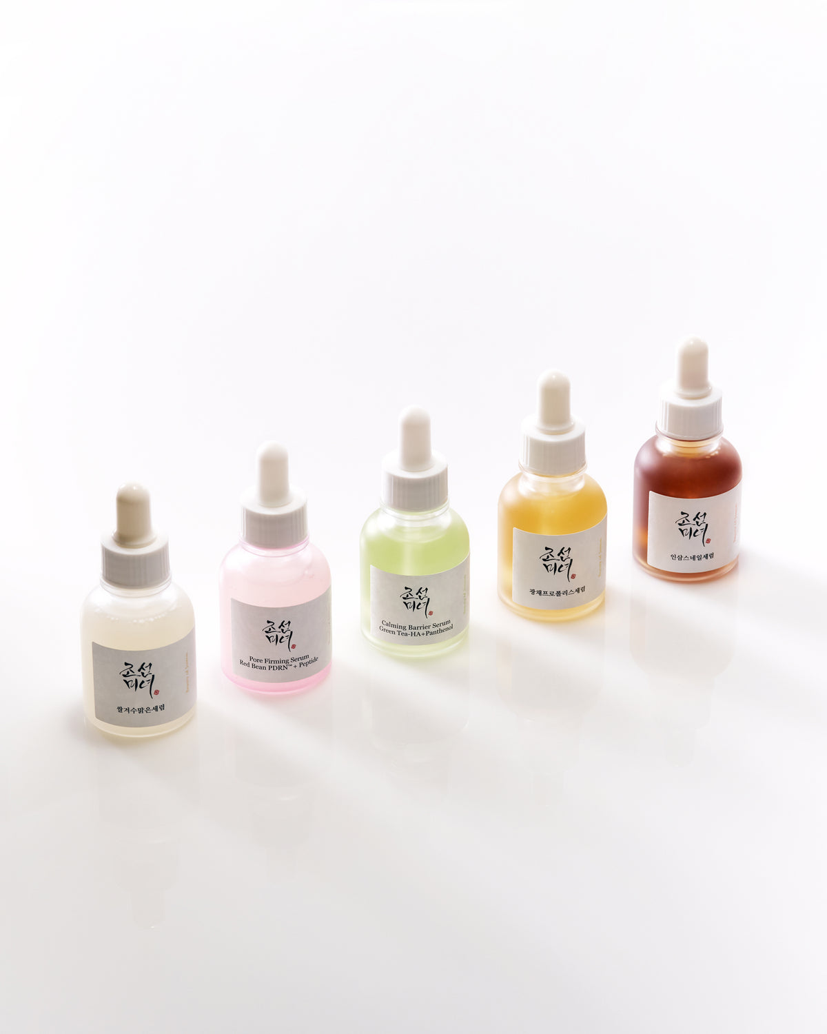 a group of bottles with different colored liquid