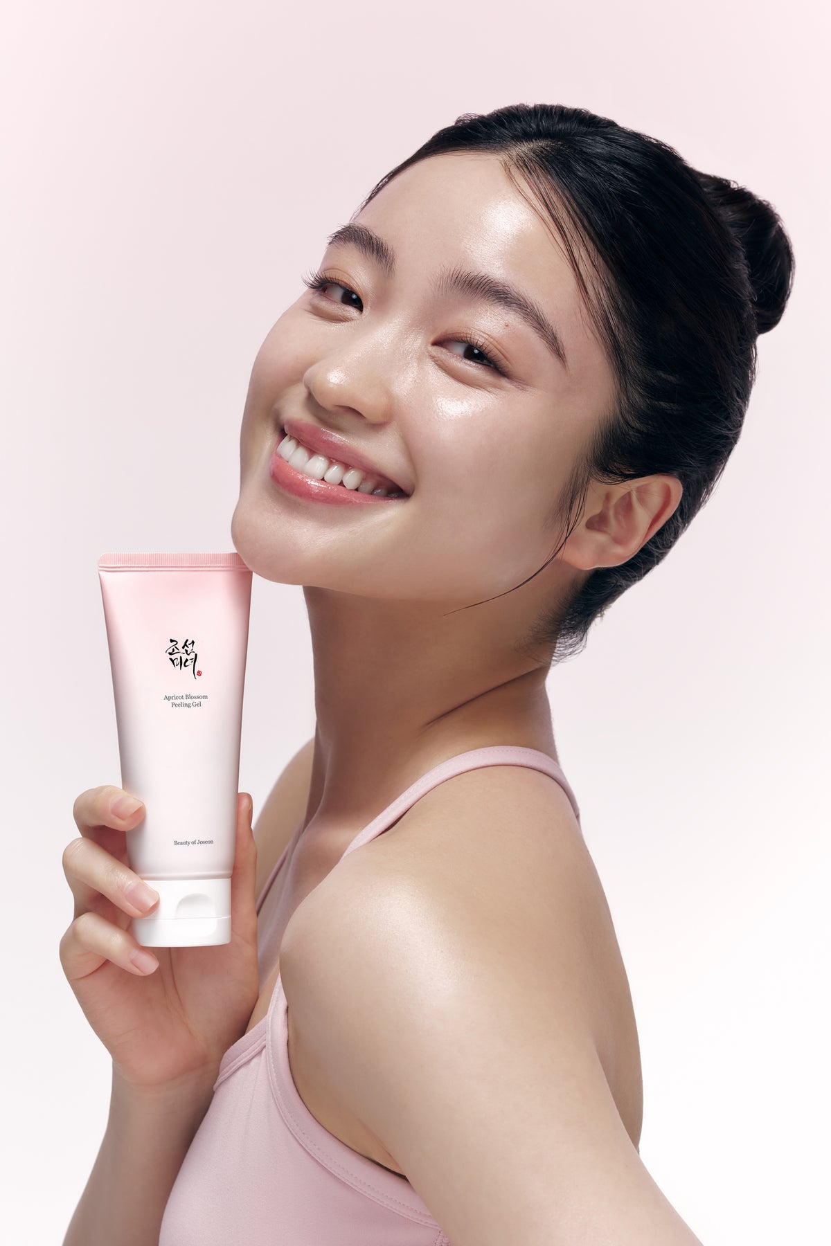 a woman holding a tube of cream